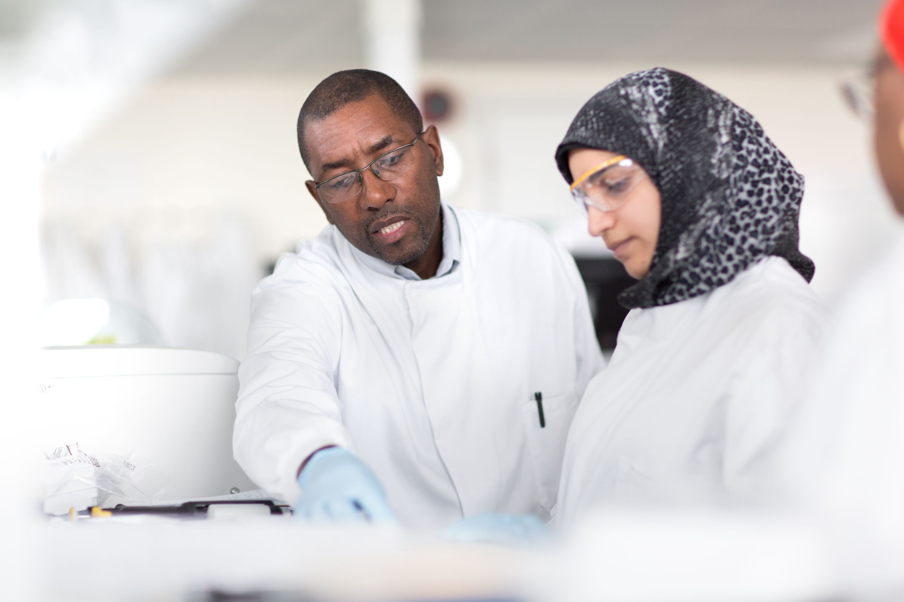 A lecturer speaking to a female student