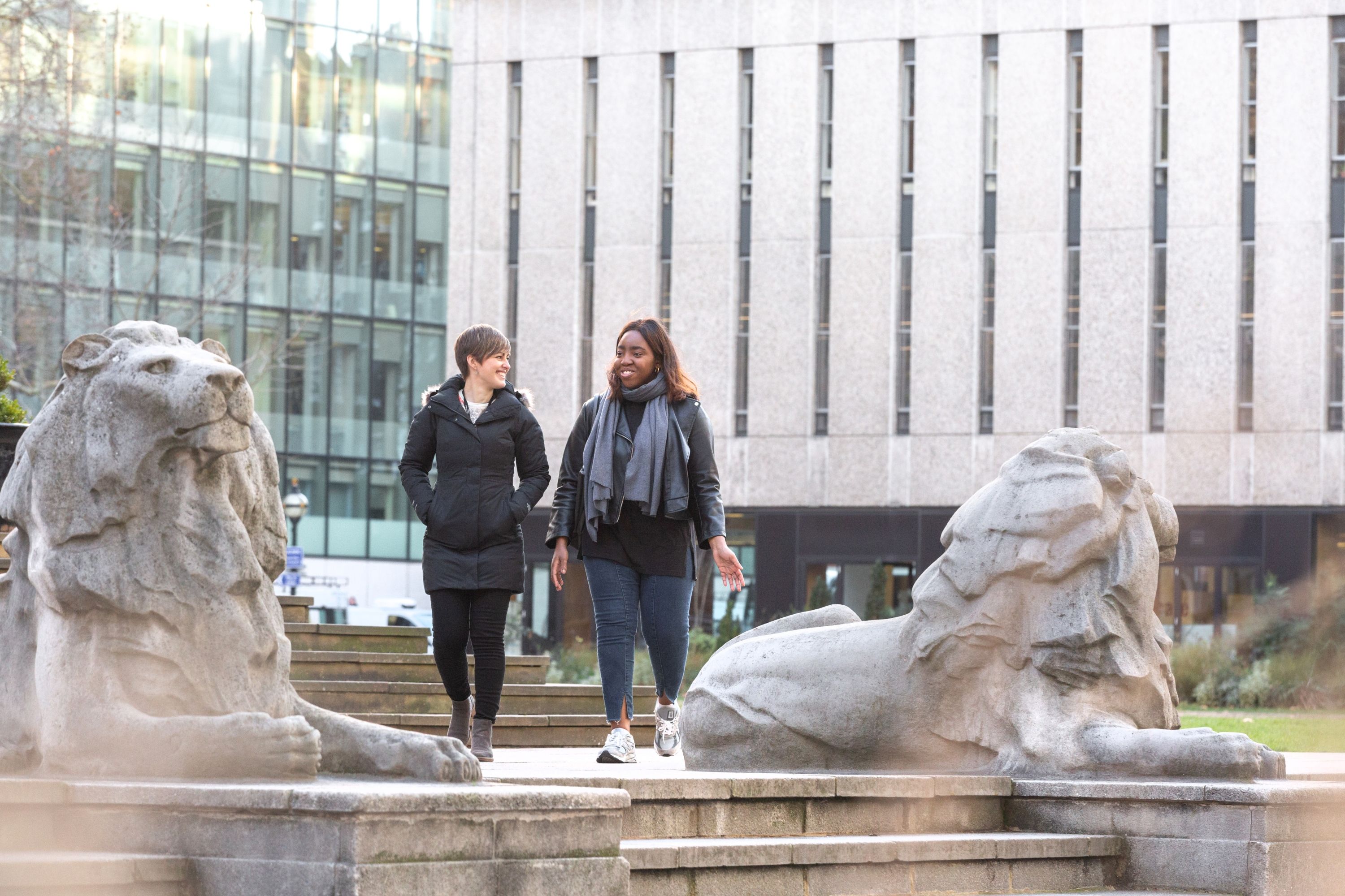 Two women walking on campus