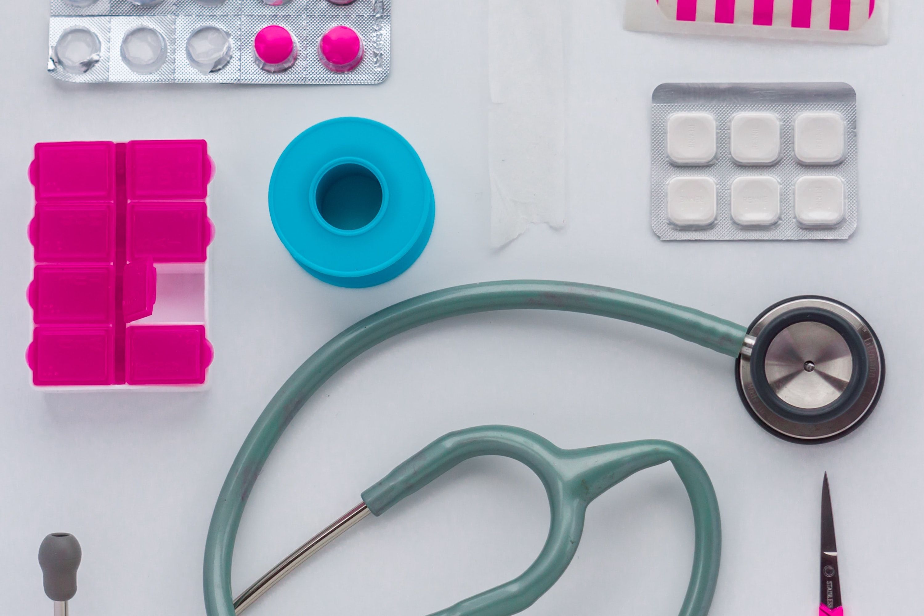 Miscellaneous clinical equipment such as a stethoscope, tablets and scissors.