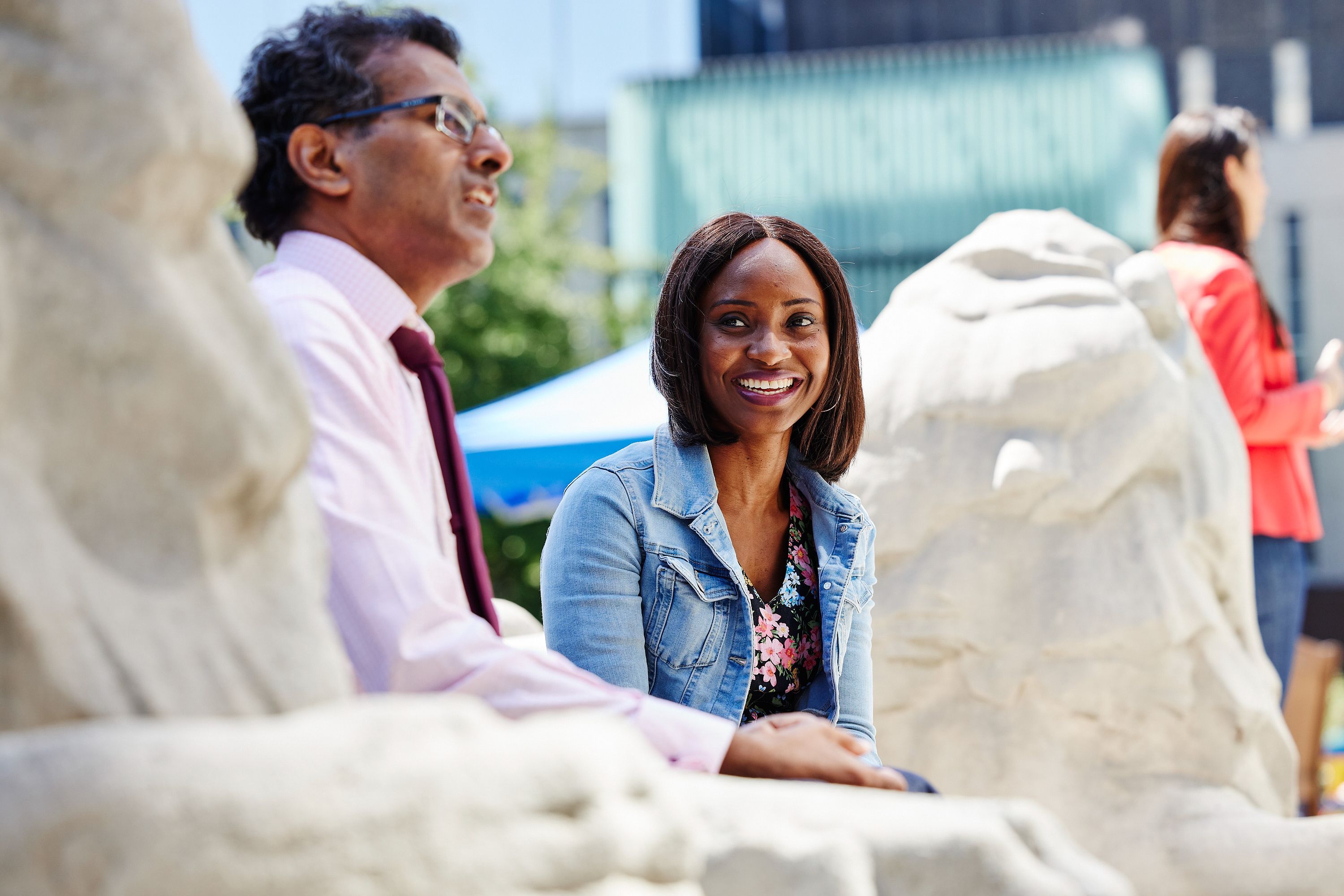 Two students sat near the lions in under the Queen's Tower