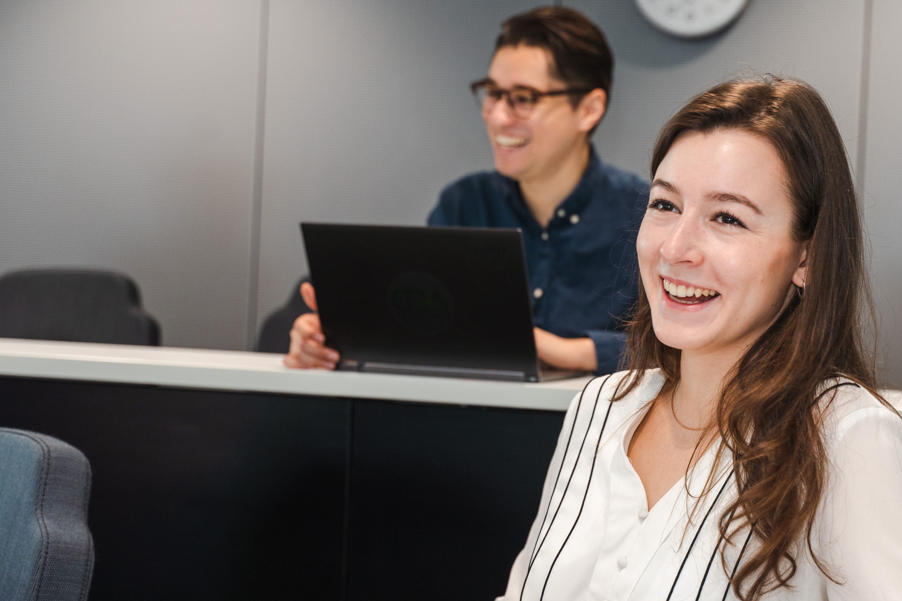 Two students laughing in a lecture theatre