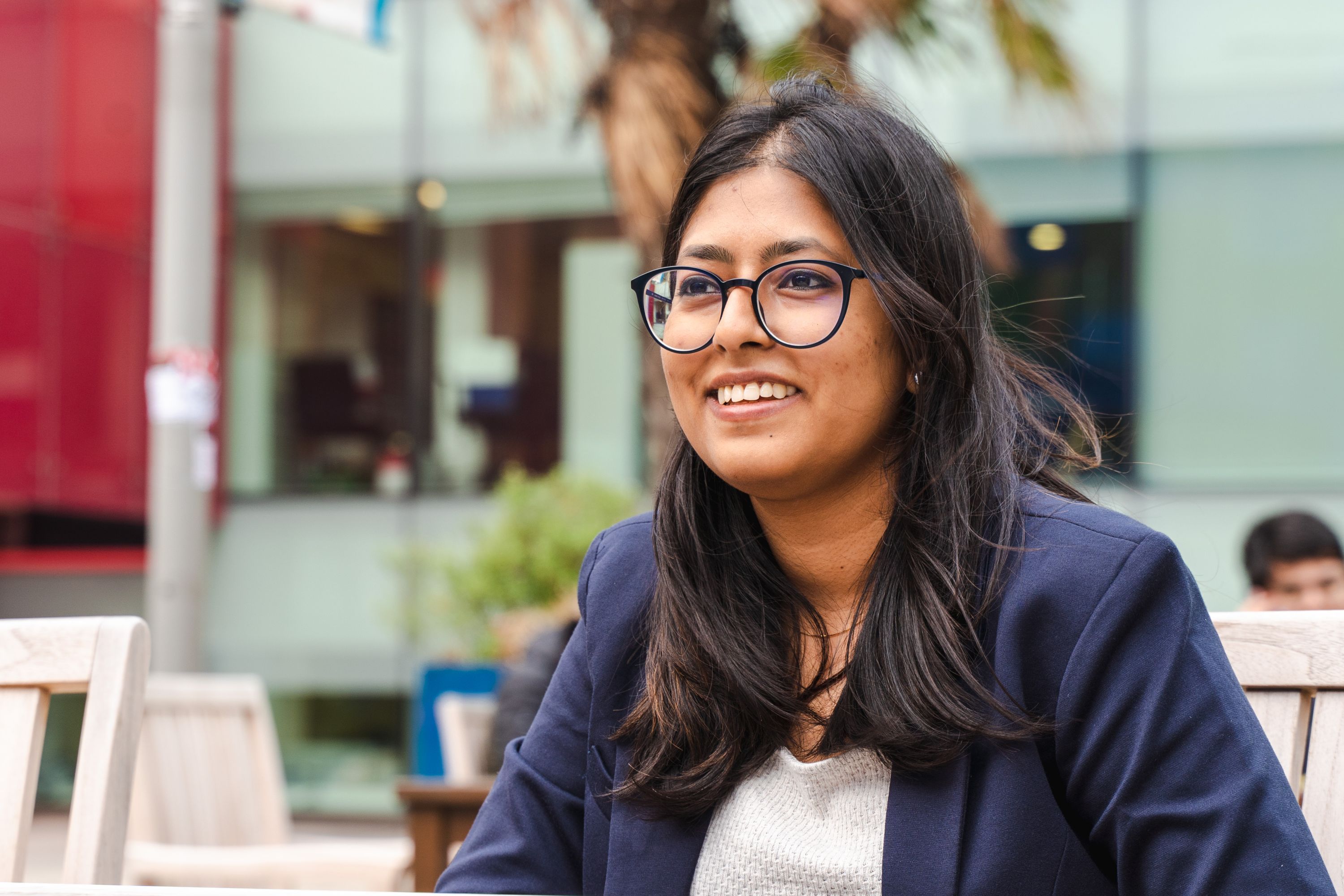 Female student sat outside on campus