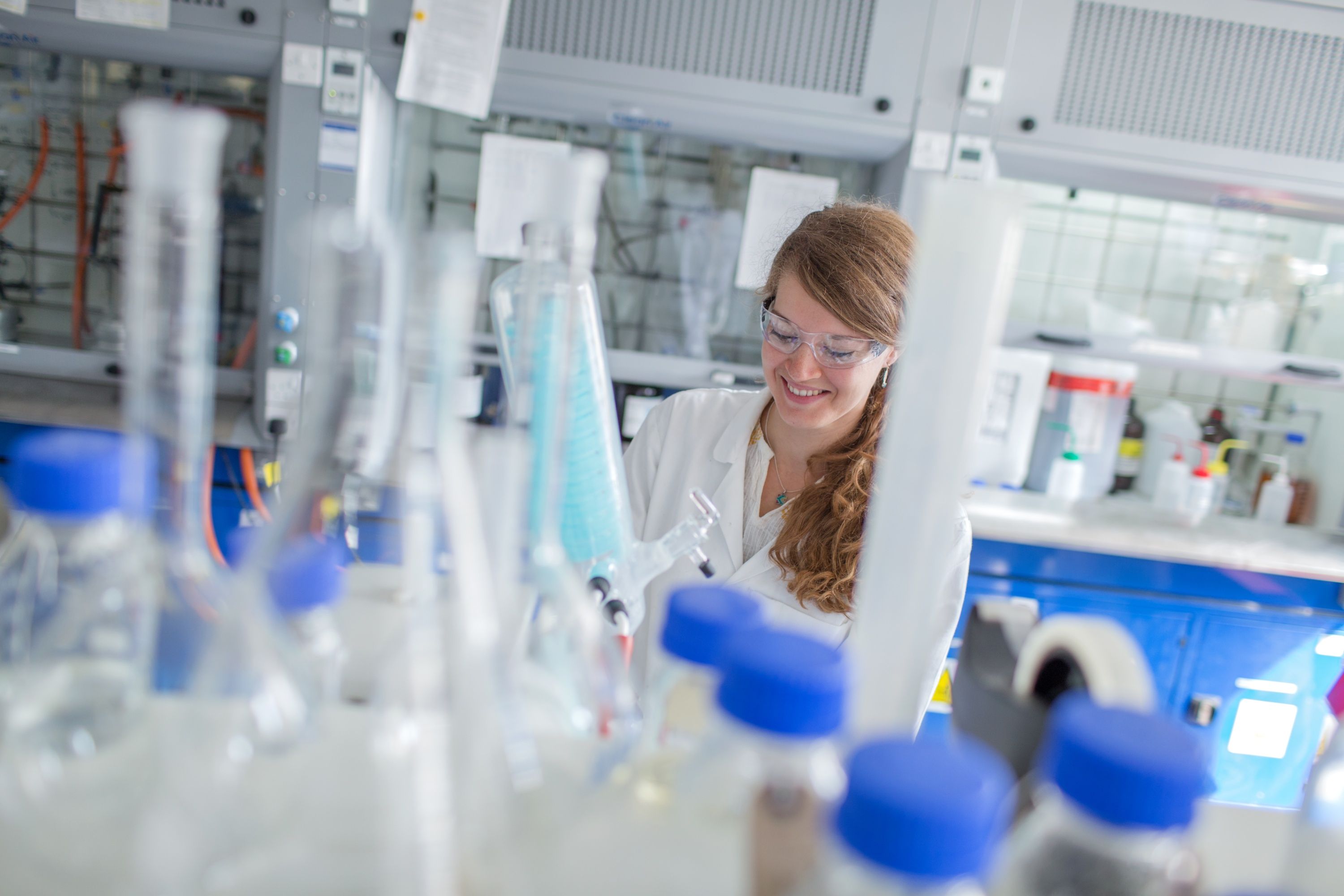 A female student smiling in a laboratory