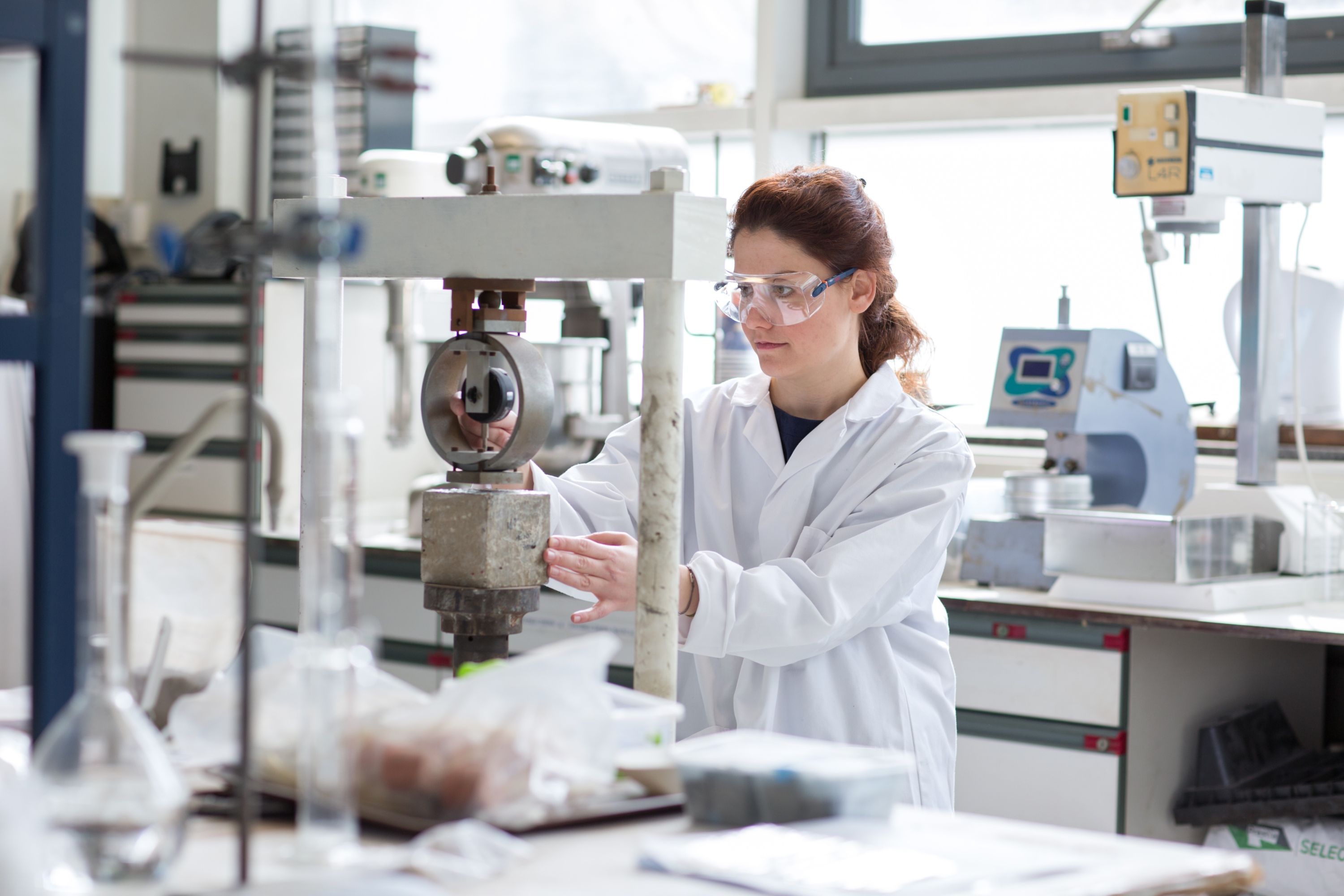 Female student working with machinery