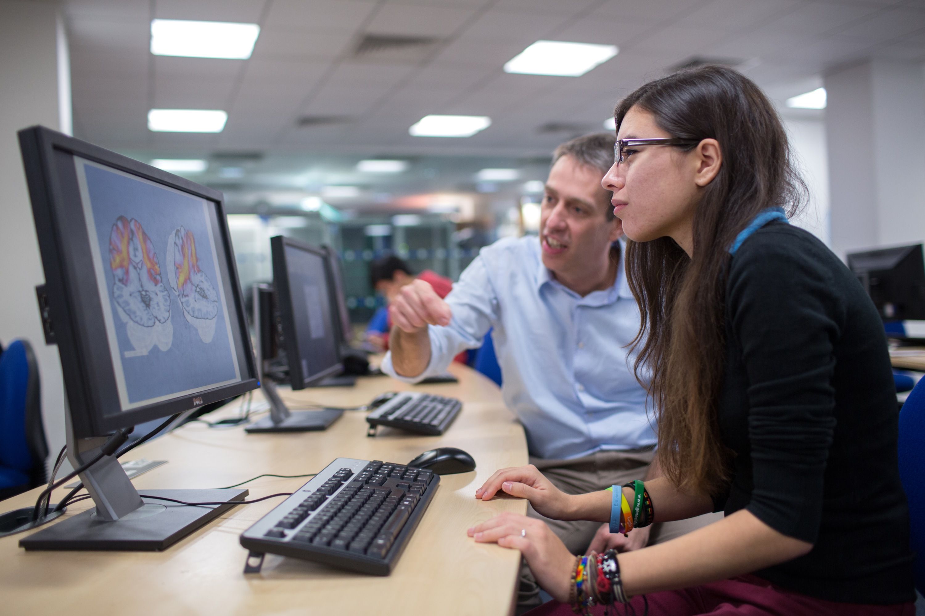 A student and a lecturer looking at a computer