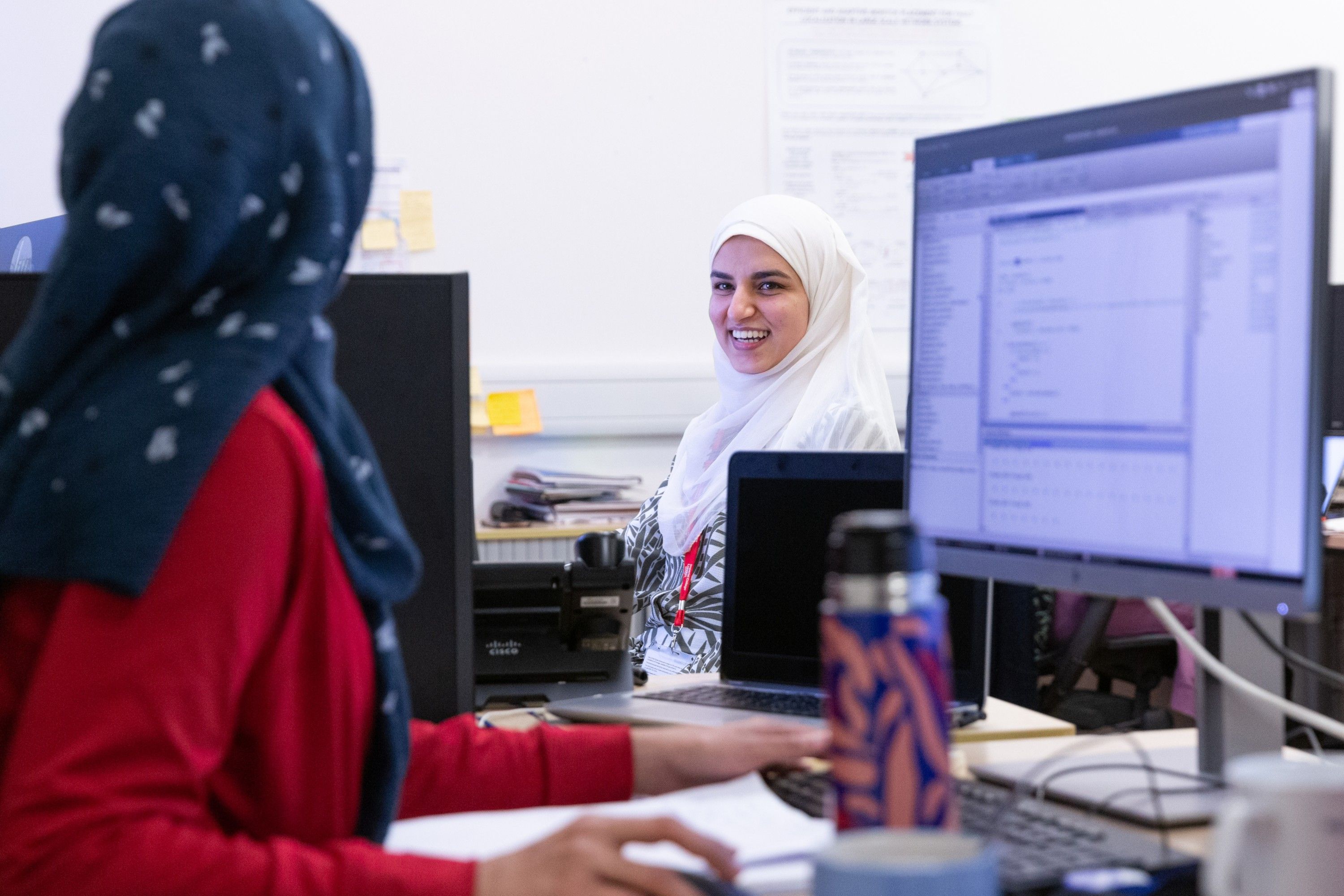 Two female students in a computer lab