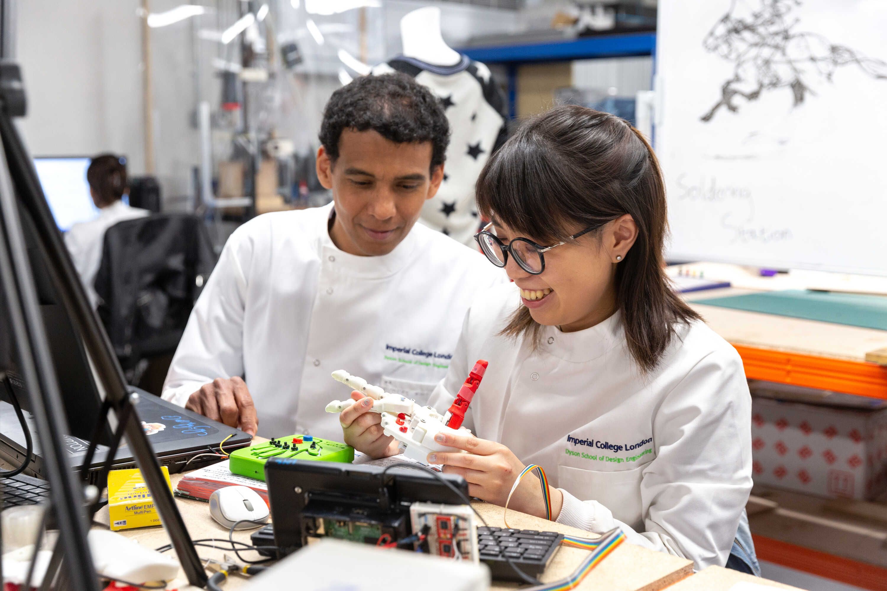 Dr Nicolas Rojas and student working on a robotic hand