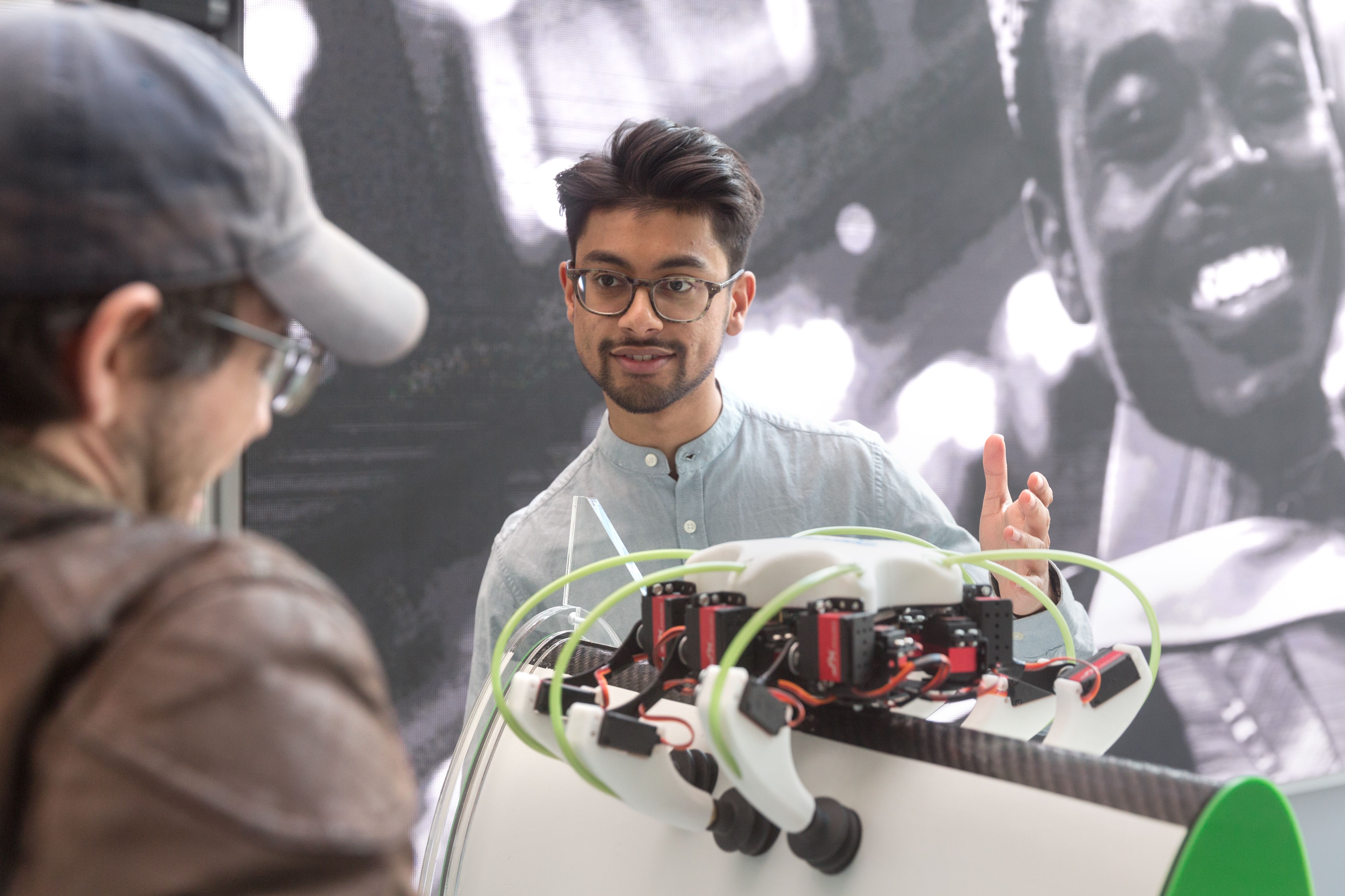 A male student in front of a machine at Imperial Hackspace