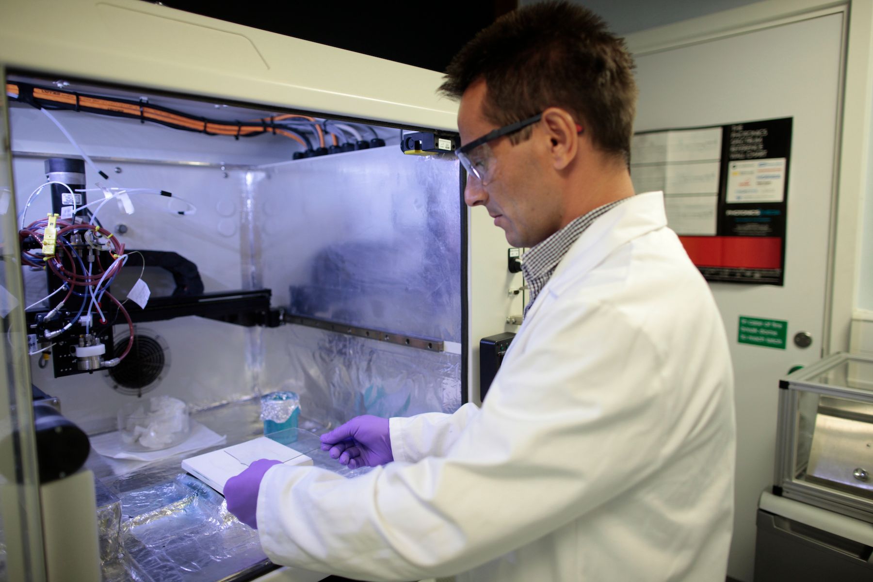 Reader in Experimental Physics, Thomas Anthopoulos, holding up sample