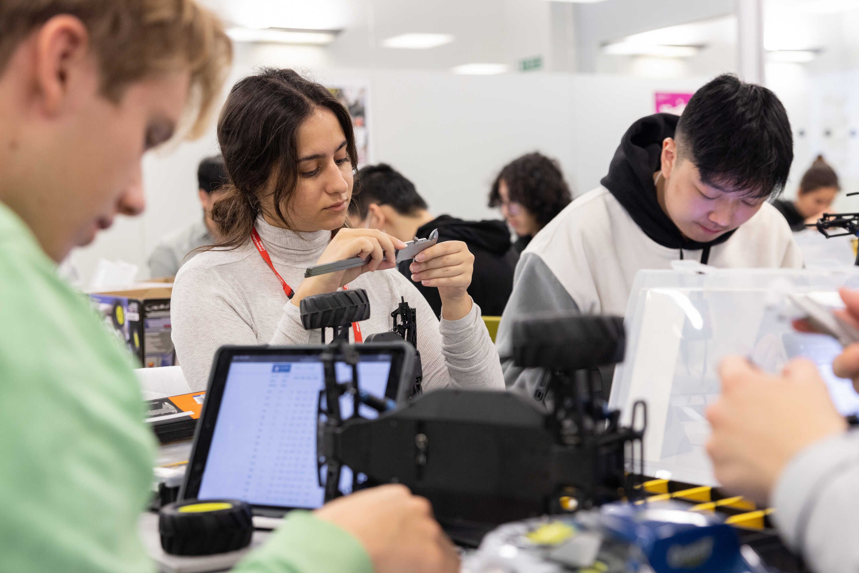 A group of students building in a workshop