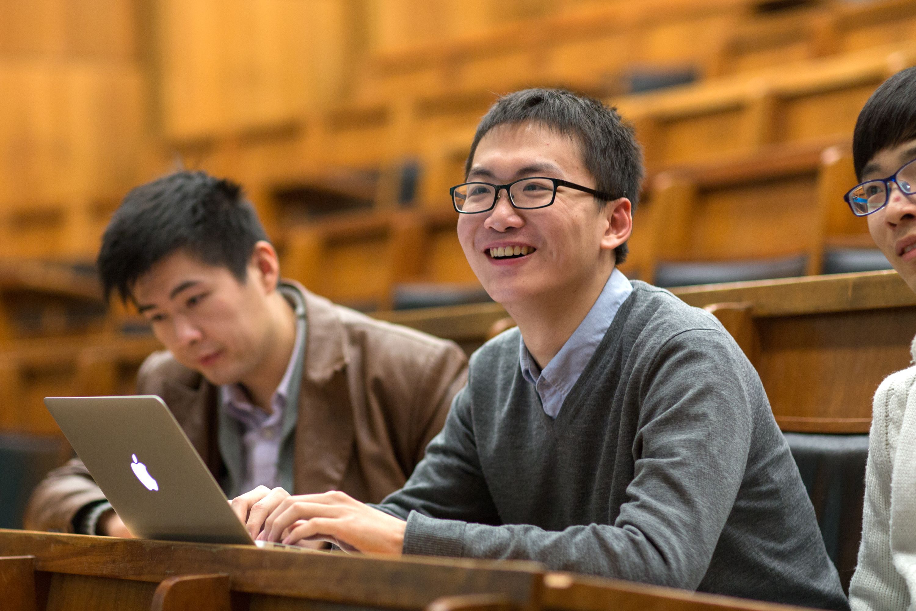 Three students in a lecture theatre