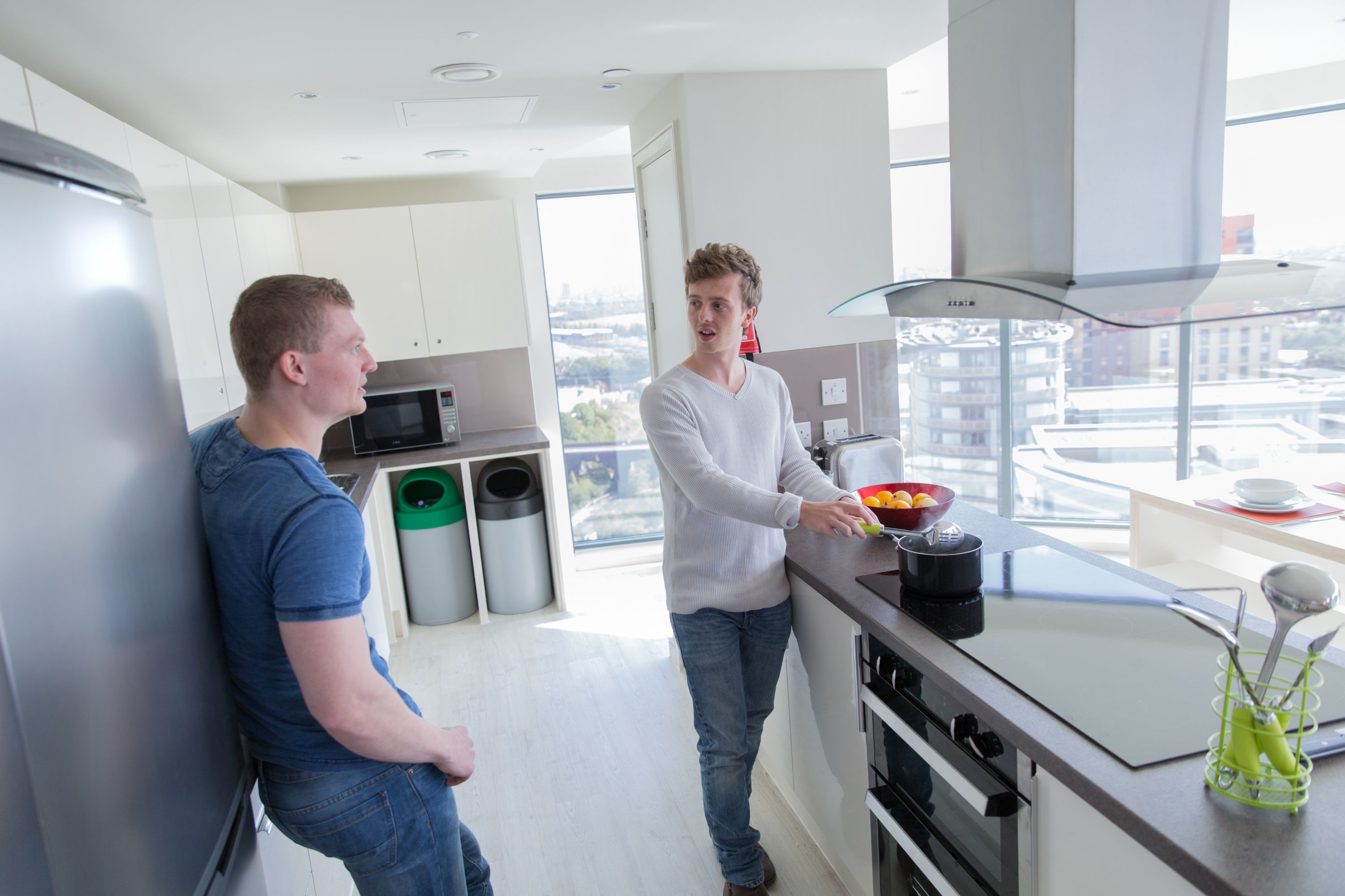 Two people cooking in a flat