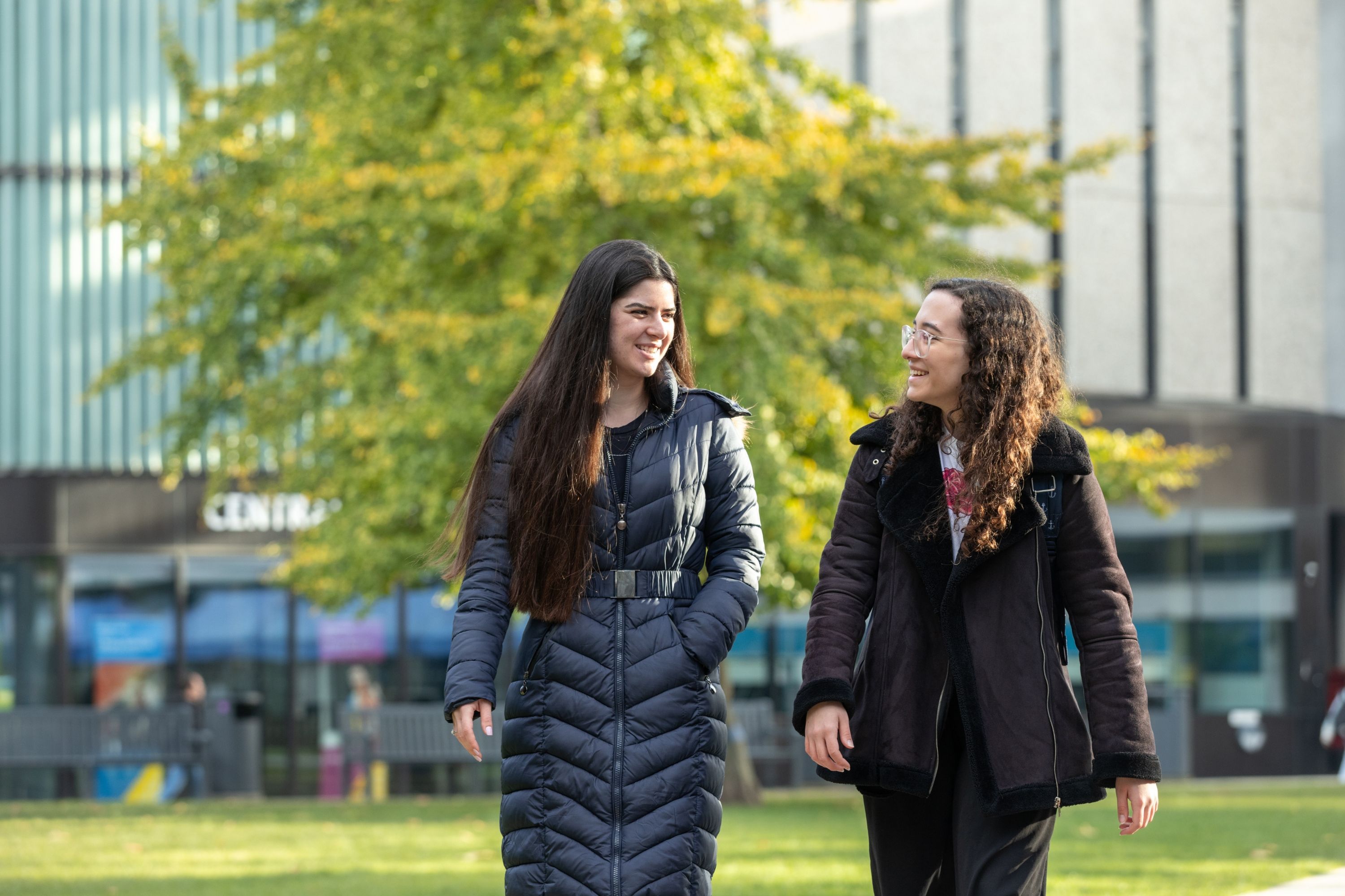 Two students walking on campus