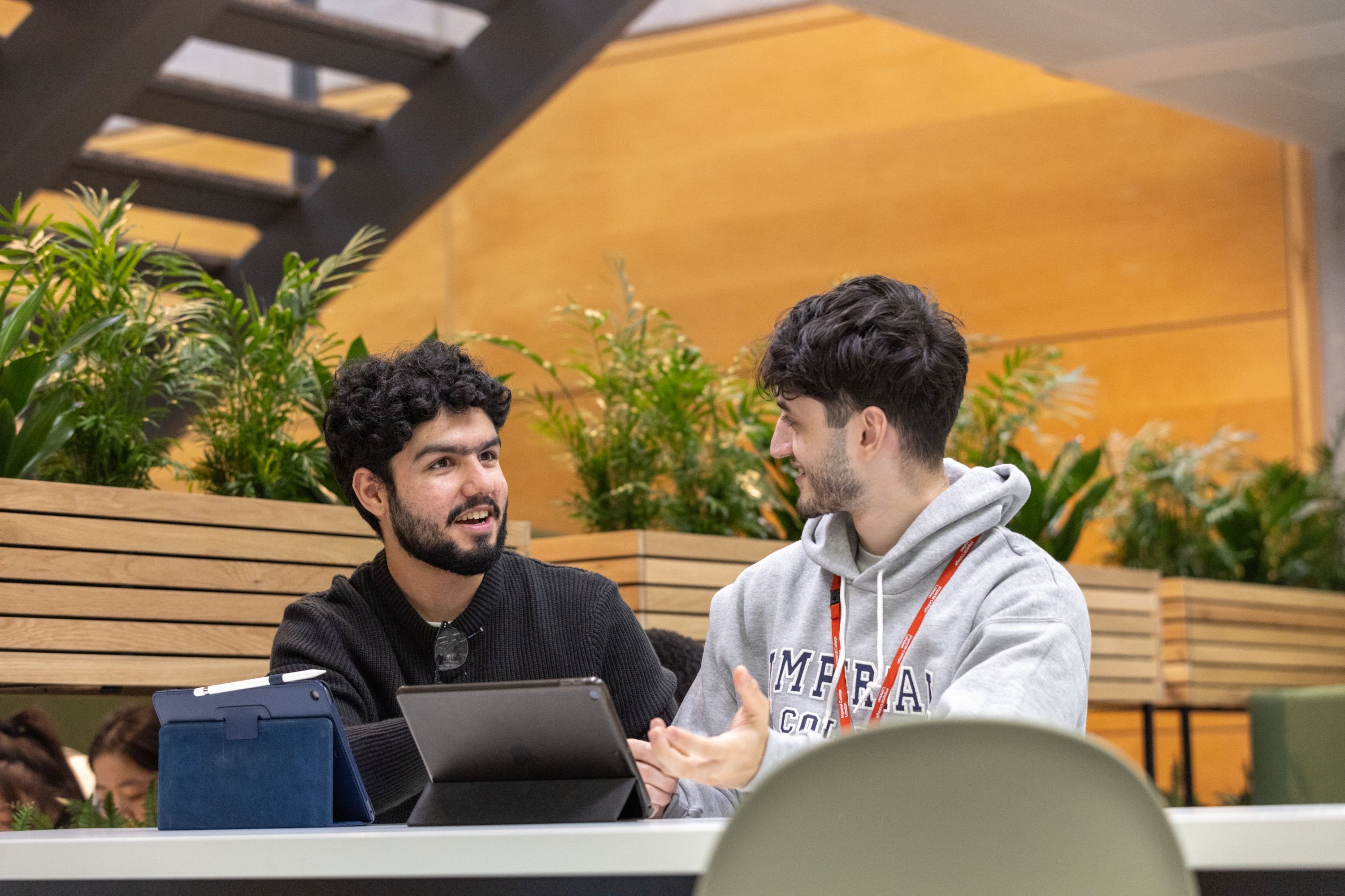 Two students laughing sat down