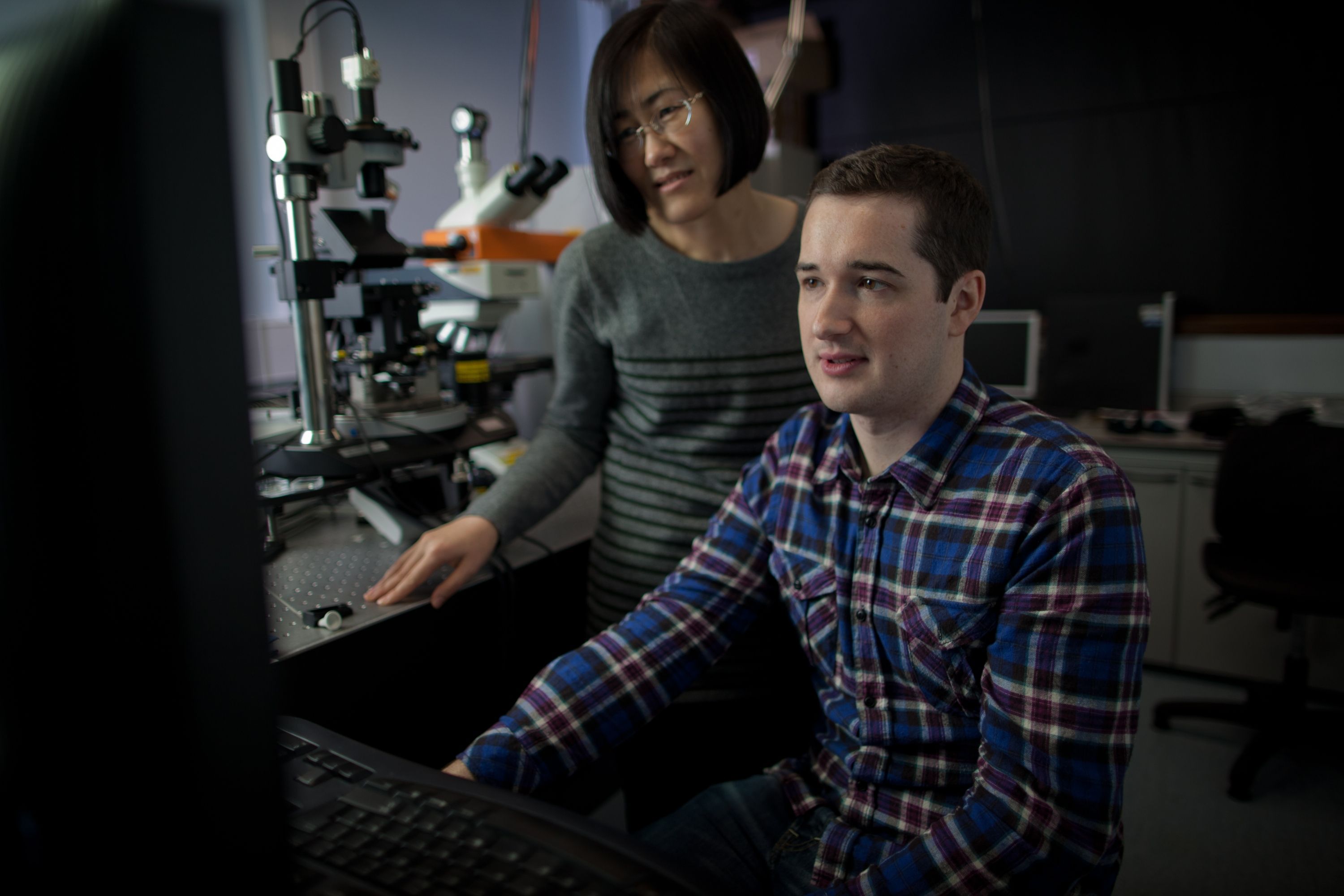 Two people looking at a computer