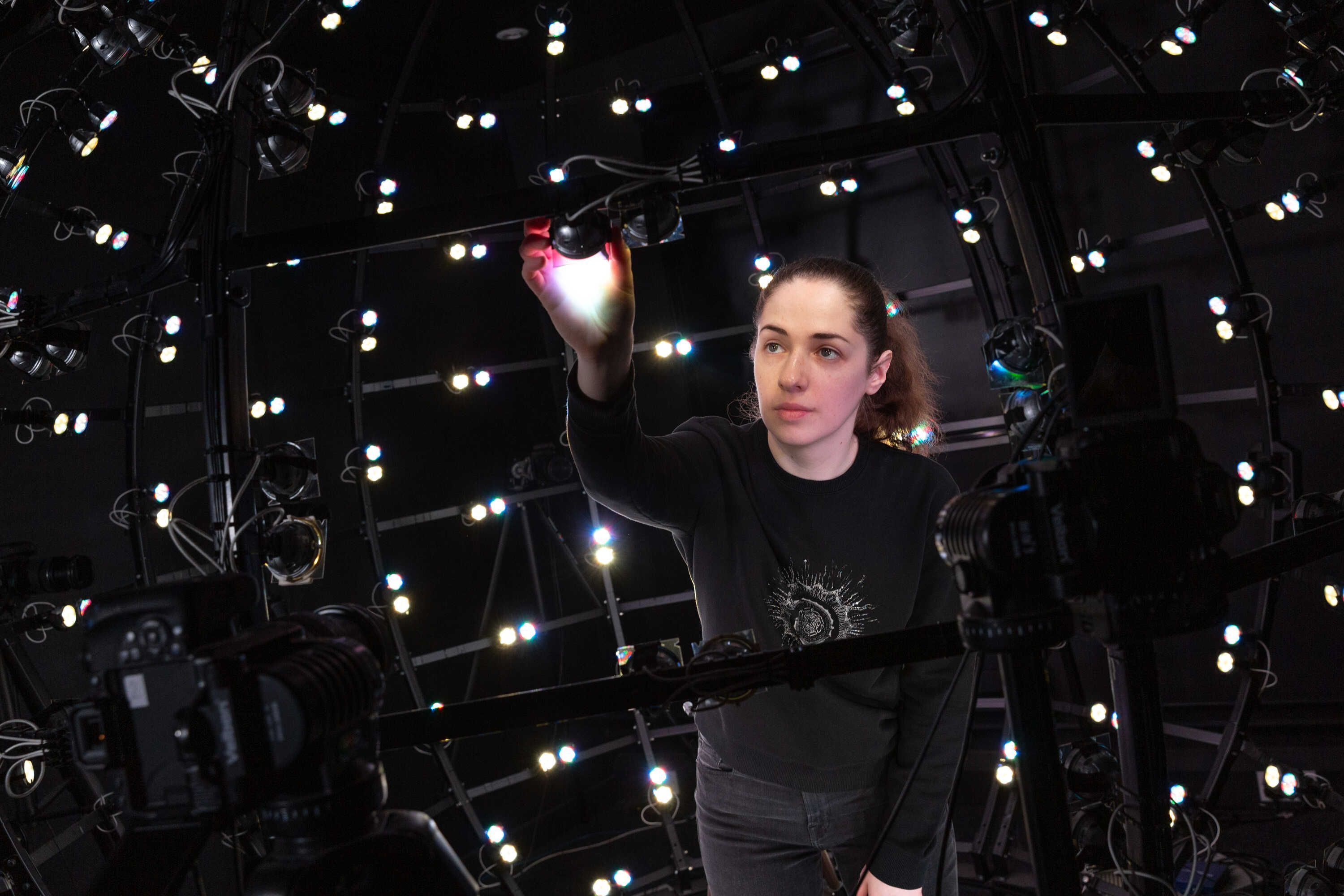 A postgraduate student working in the Multispectral Light Stage facility in the Department of Computing