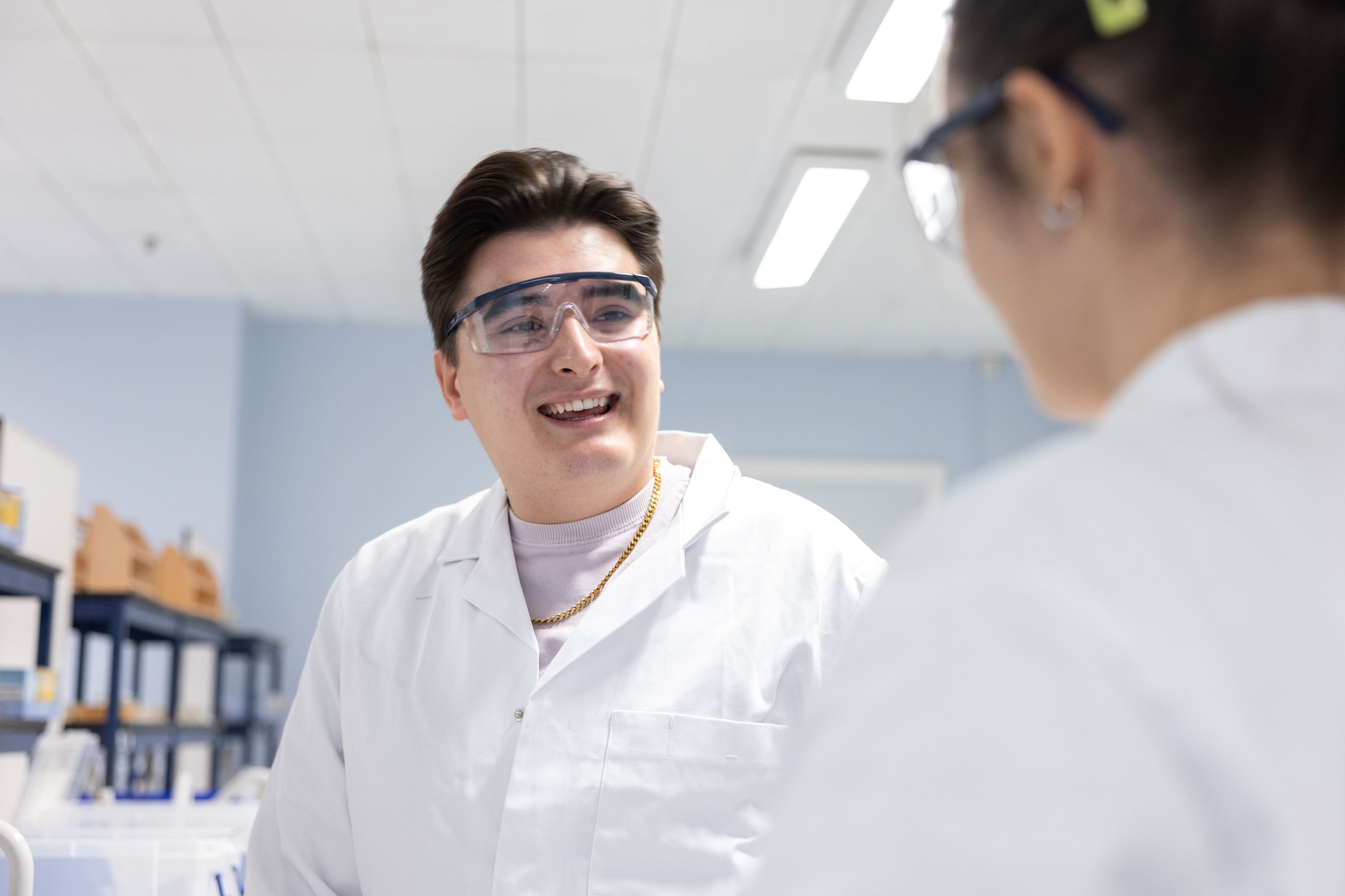 Two male students talking in a science lab