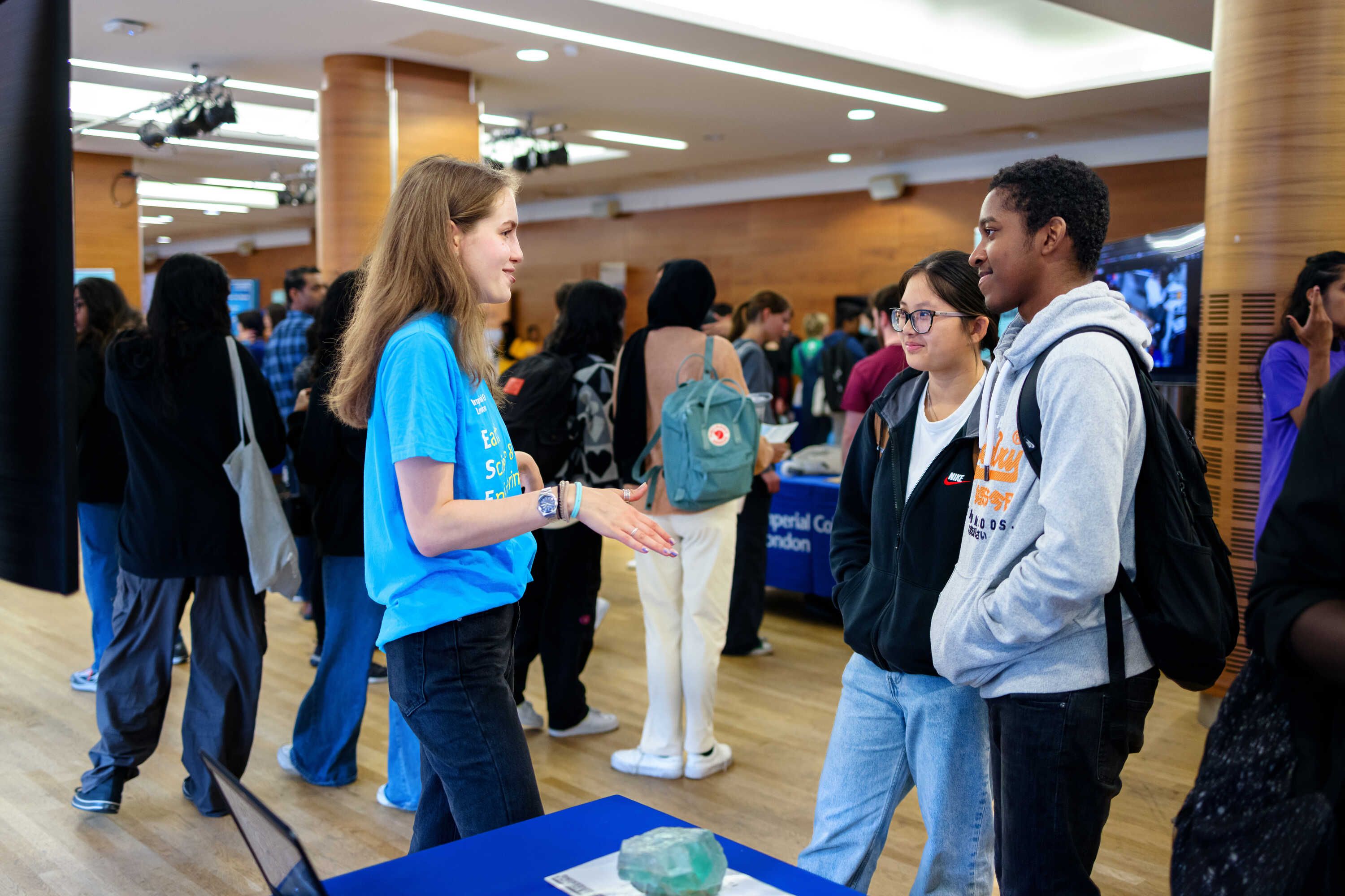 Open Day visitors chatting to a student on the Earth Science and Engineering stand