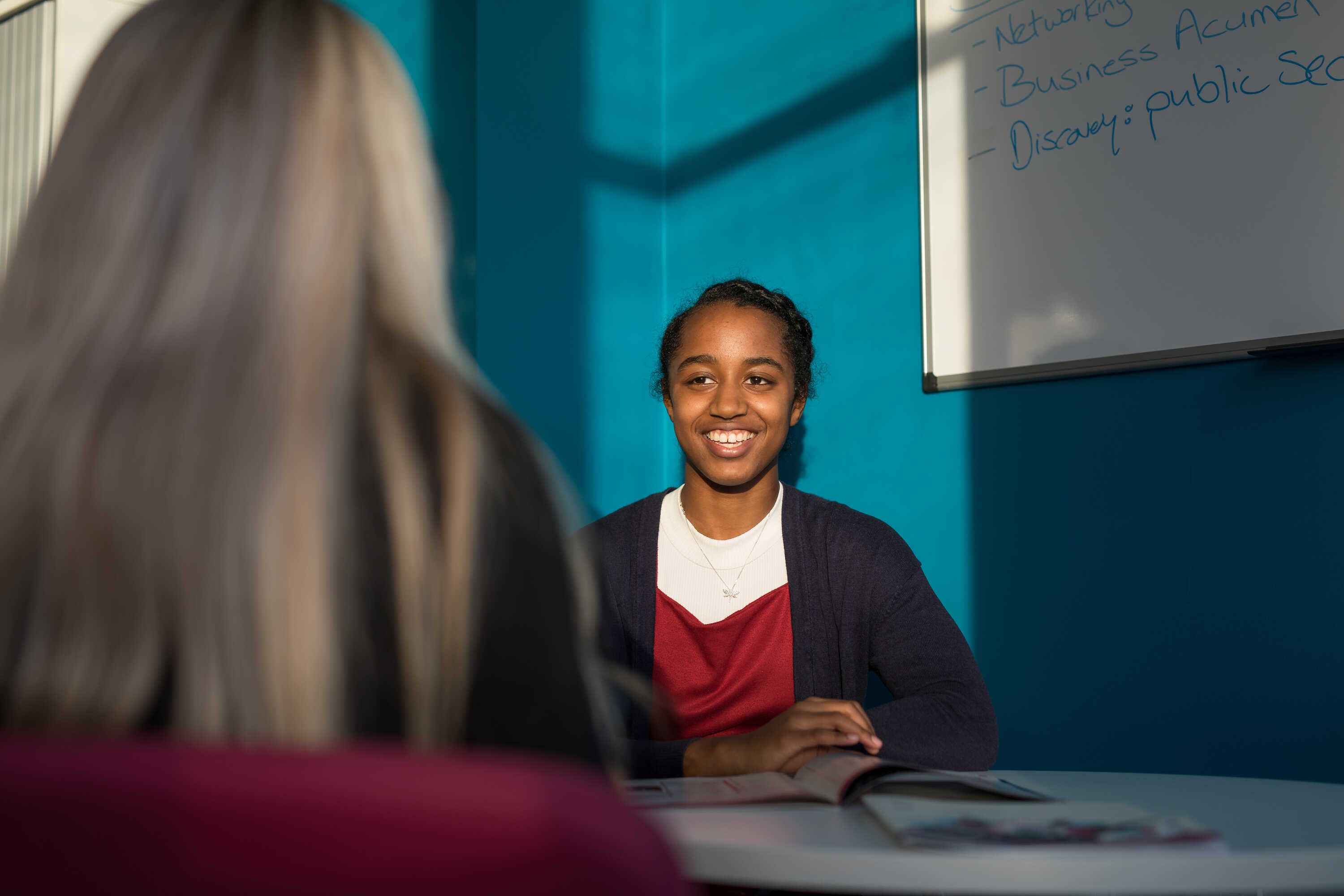 A student speaking to a member of staff