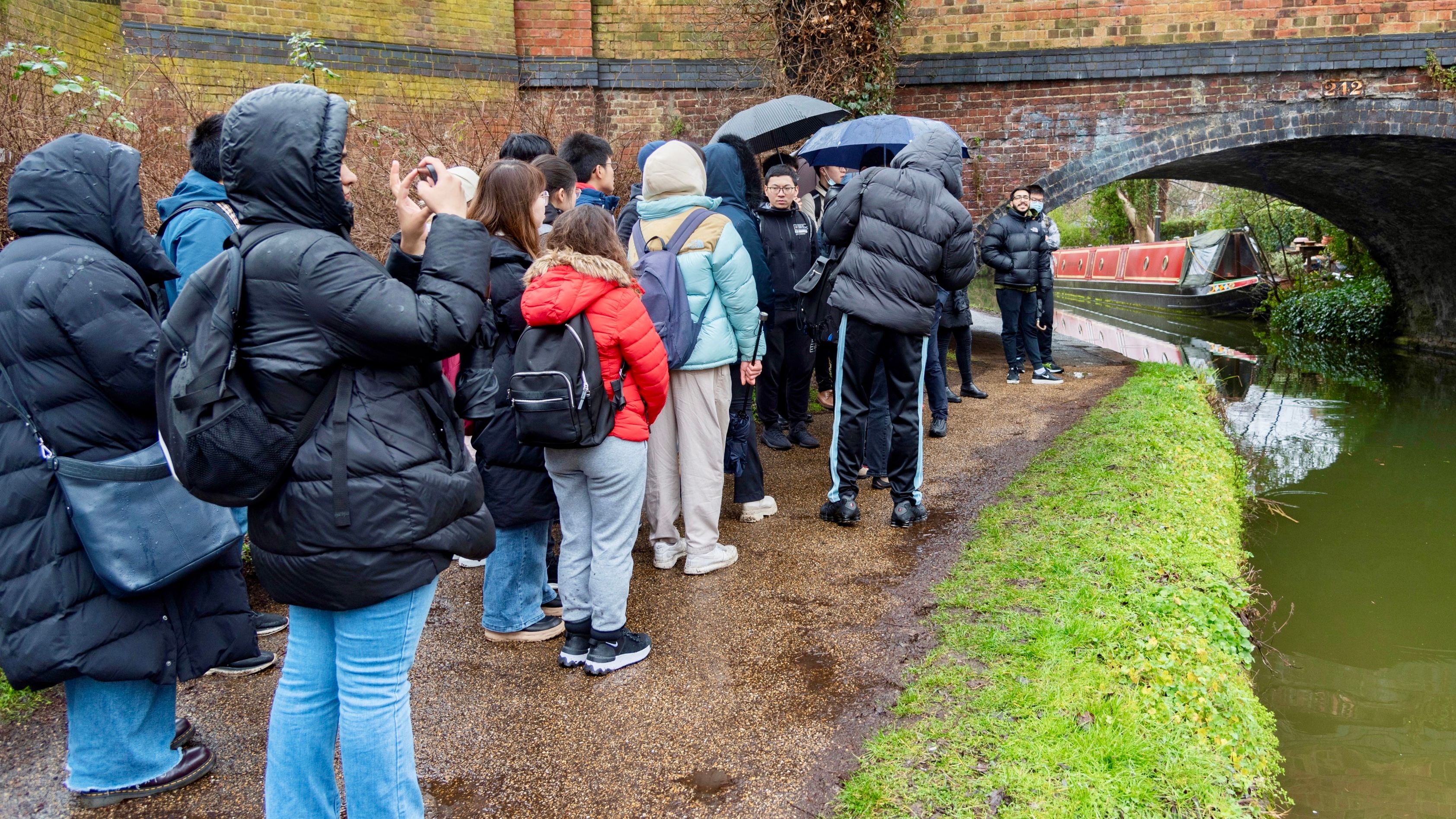 Figure shows MSc students are doing survey at a masonry bridge