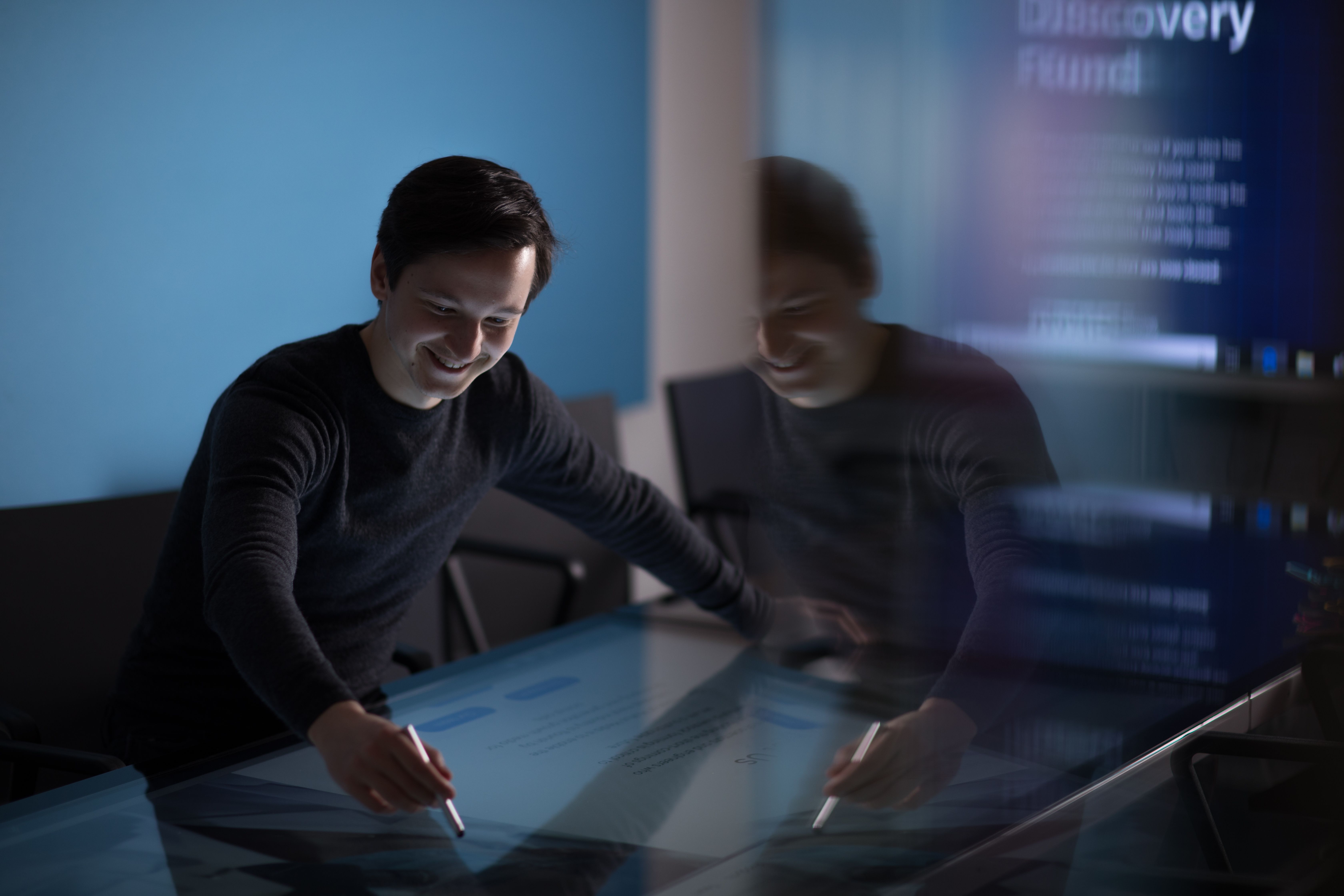 A molecular bioengineering student demonstrates his work on a screen in the Enterprise Lab