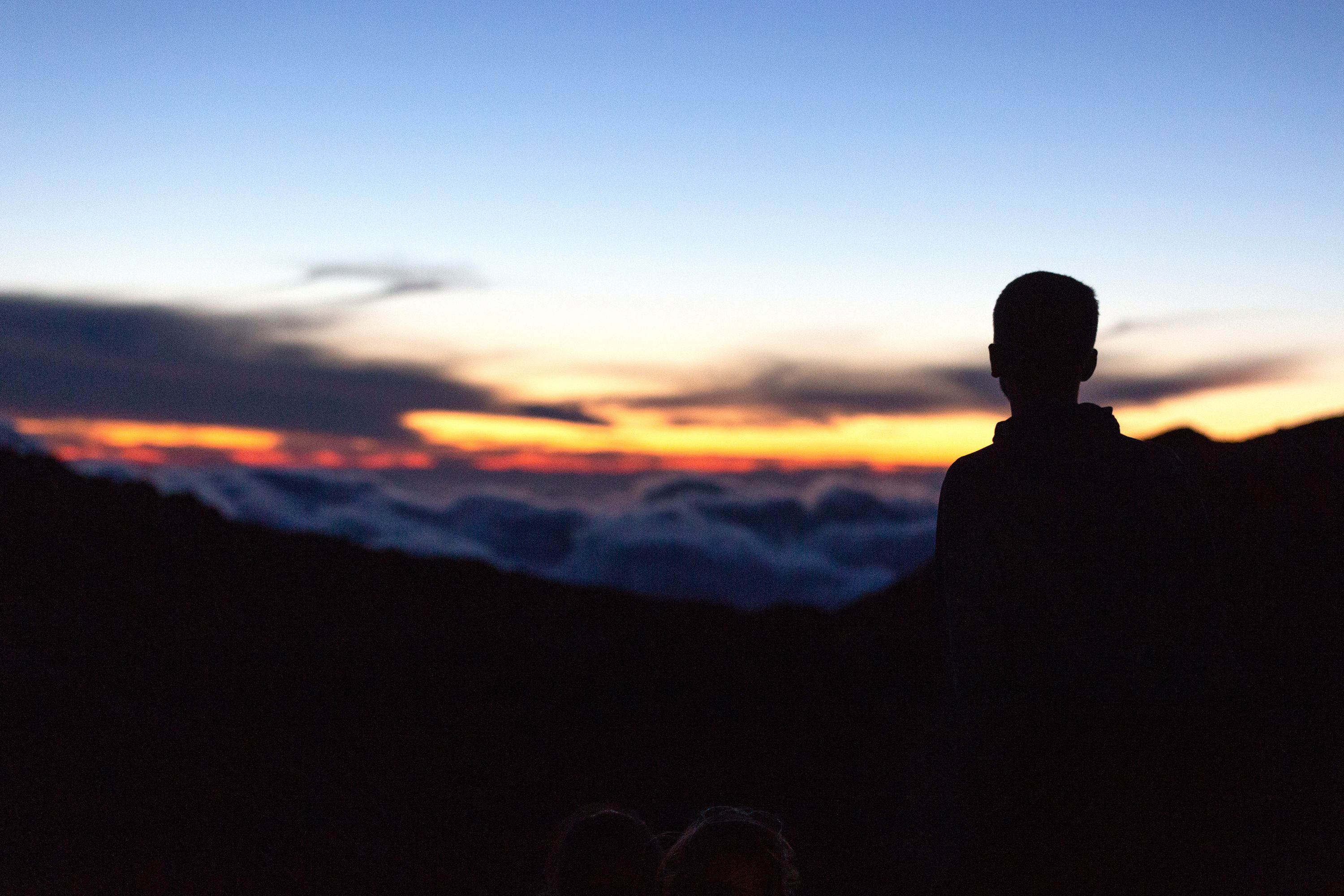 A student watching the sunrise over mountains in Crete