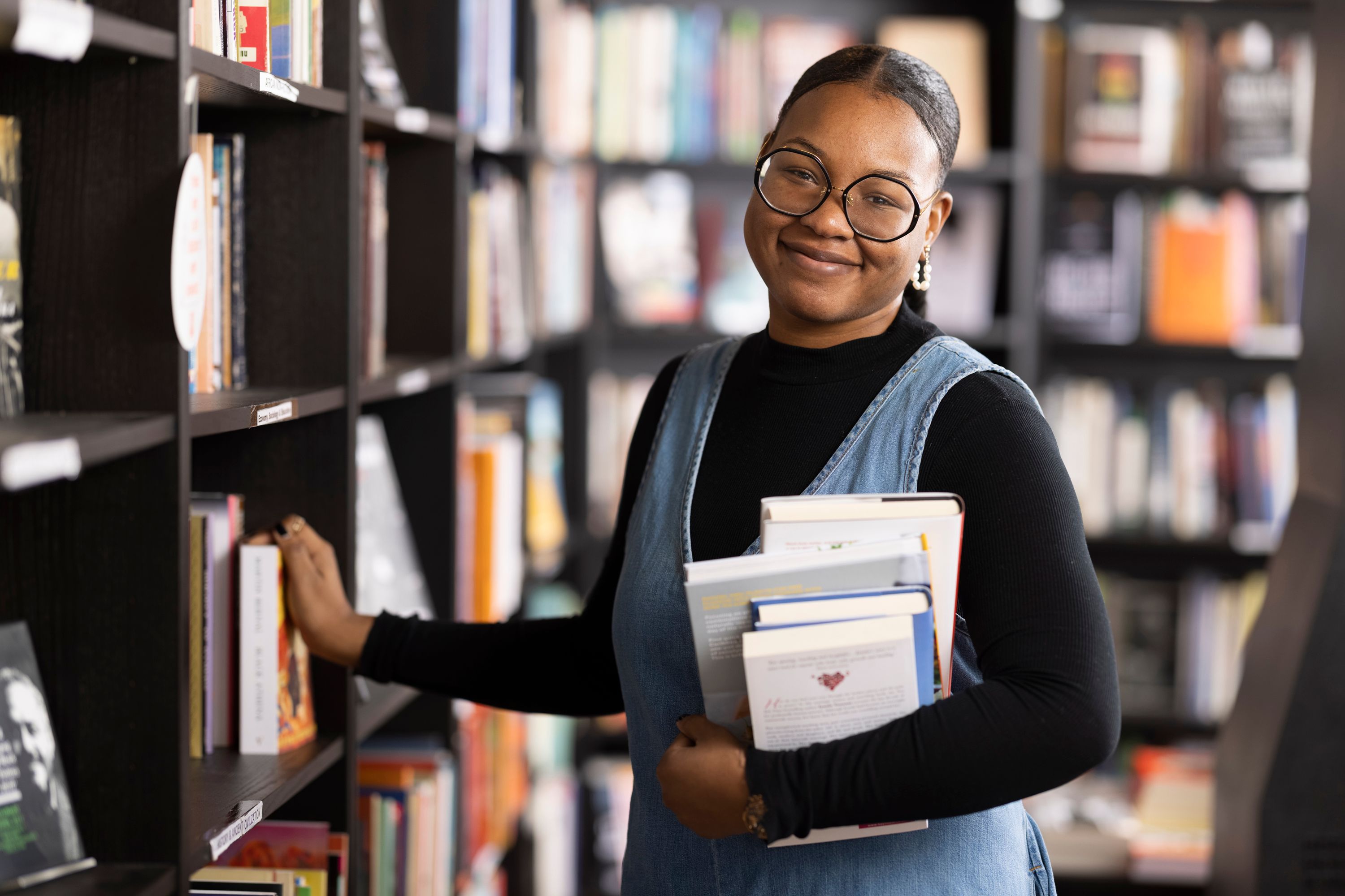 Faridah Abdulrazaq, MSc Climate Change, Management & Finance, in a library